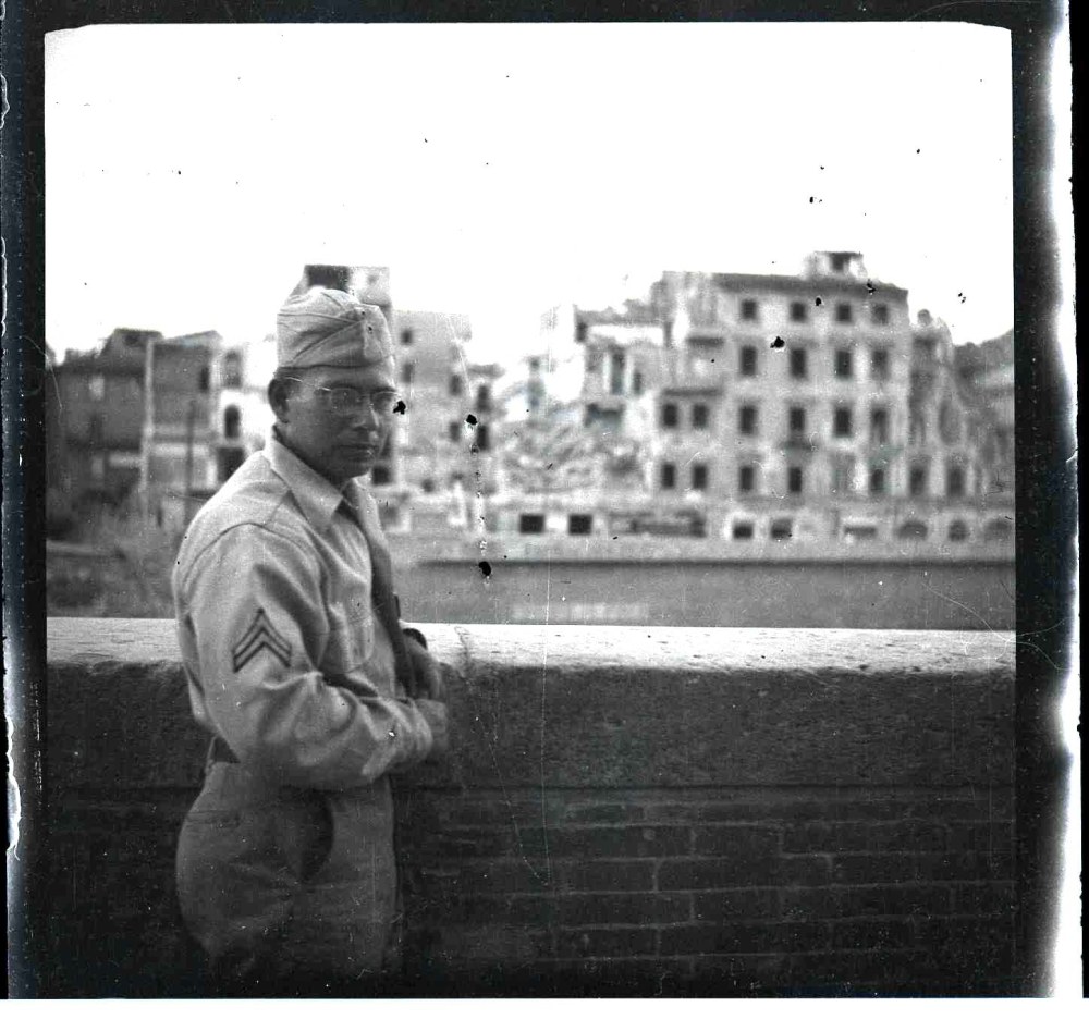 Philip in front of bombed buildings on the bank of the Arno River. Florence, Italy, Fall, 1945.