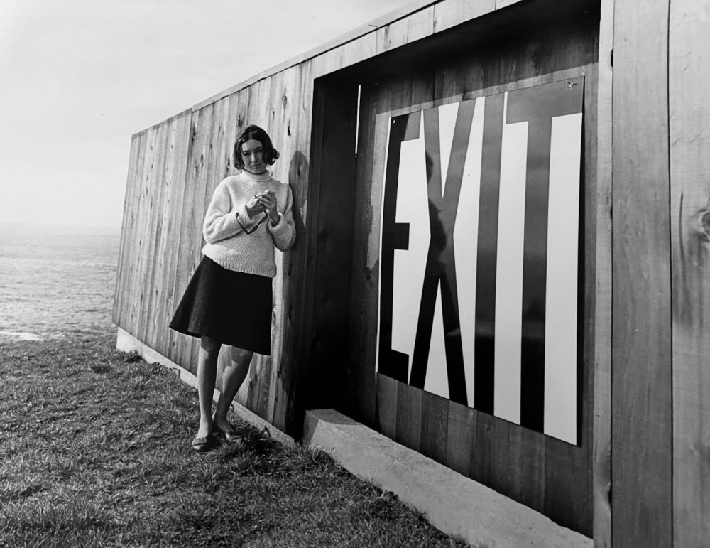 Barbara Stauffacher Solomon with her &amp;ldquo;Exit&amp;rdquo; sign, The Sea Ranch, 1965.

&amp;nbsp;