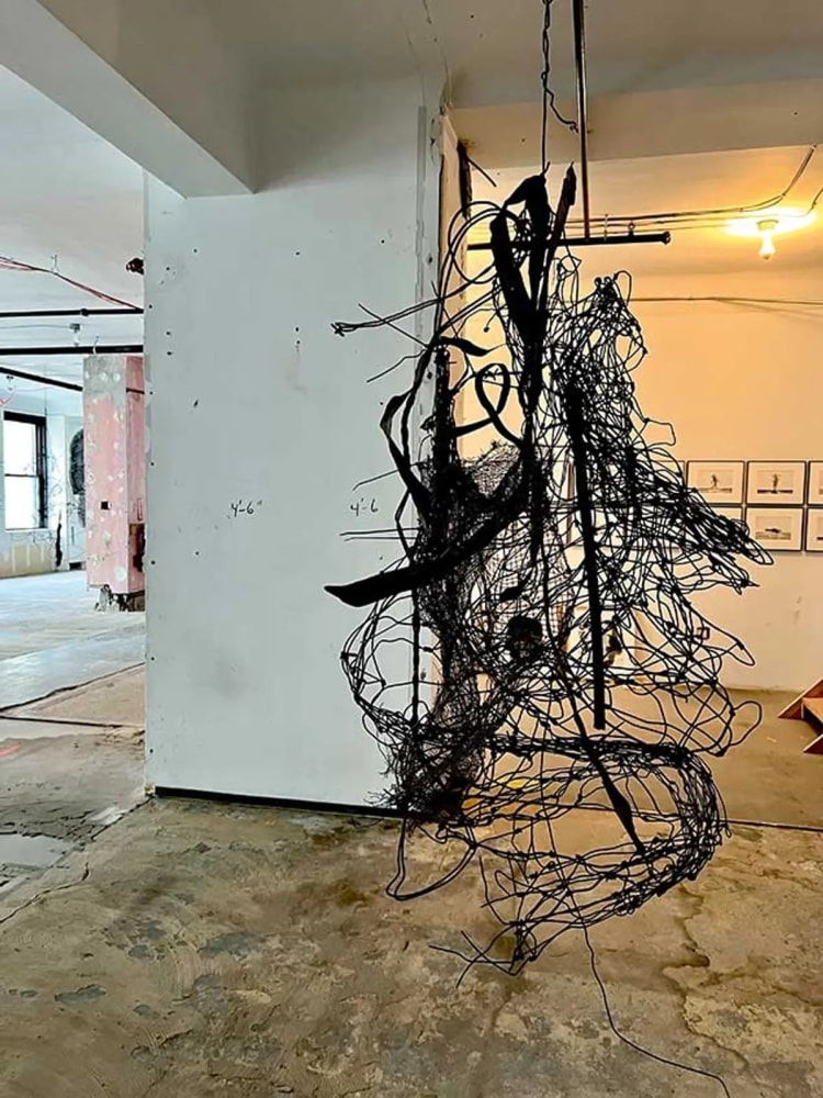 Hanging wire sculpture in a gallery