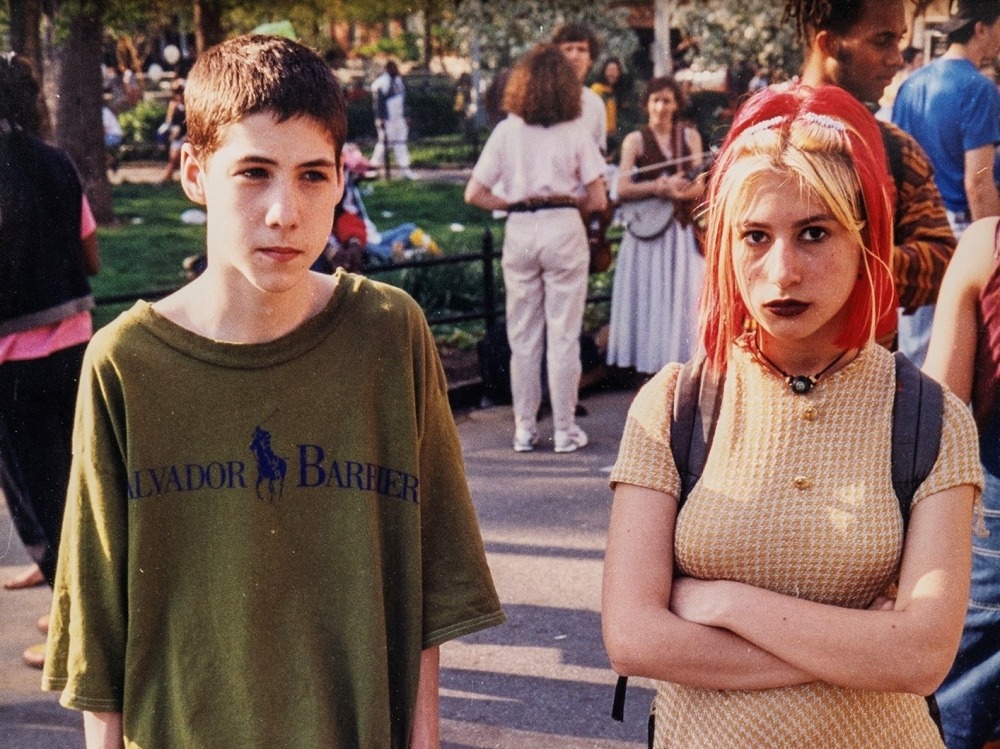 A teenage boy and girl standing in Washington Square Park in the early 1990s