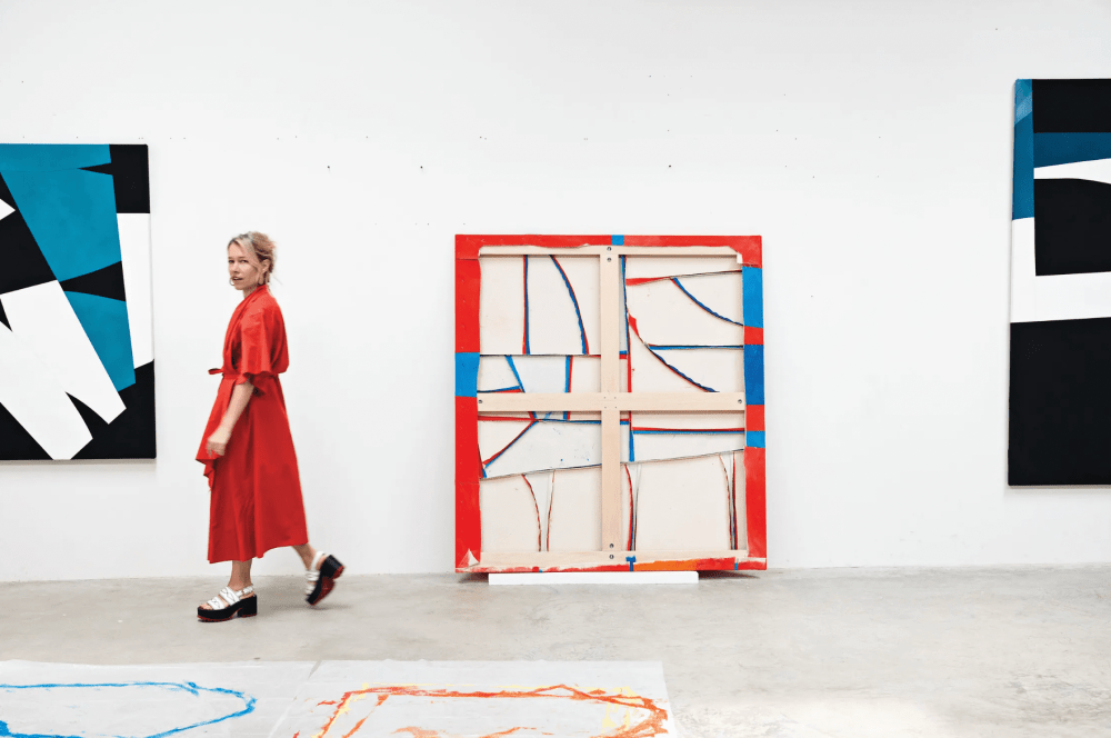 Woman standing in her painting studio