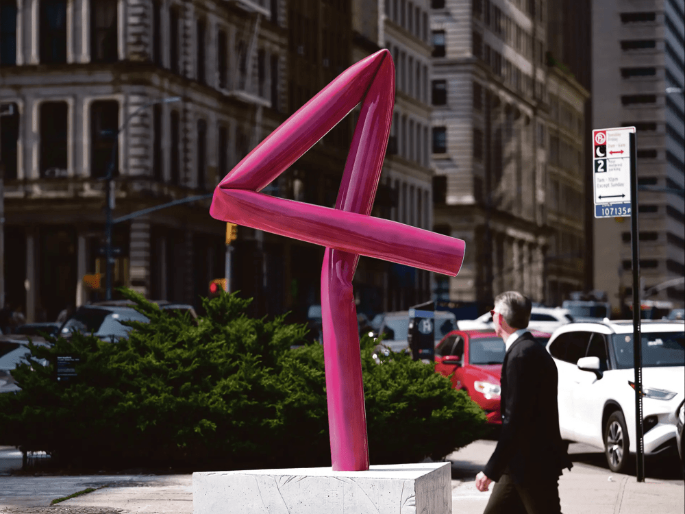 Hot pink metal sculpture twisted into the number 4
