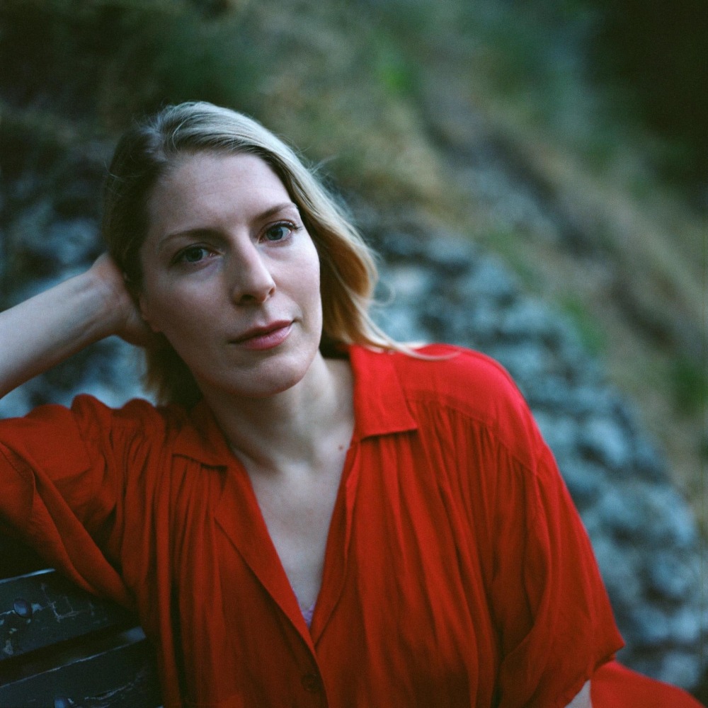 Photographic portrait of Allison Katz wearing a red shirt