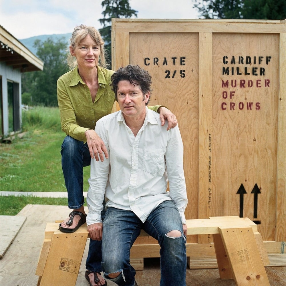 a man and a woman in front of a wooden crate