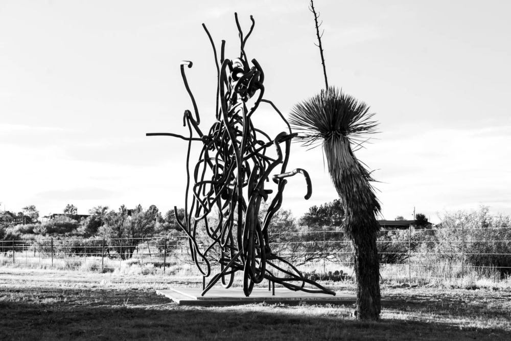 Black and white photo of a sculpture in a desert