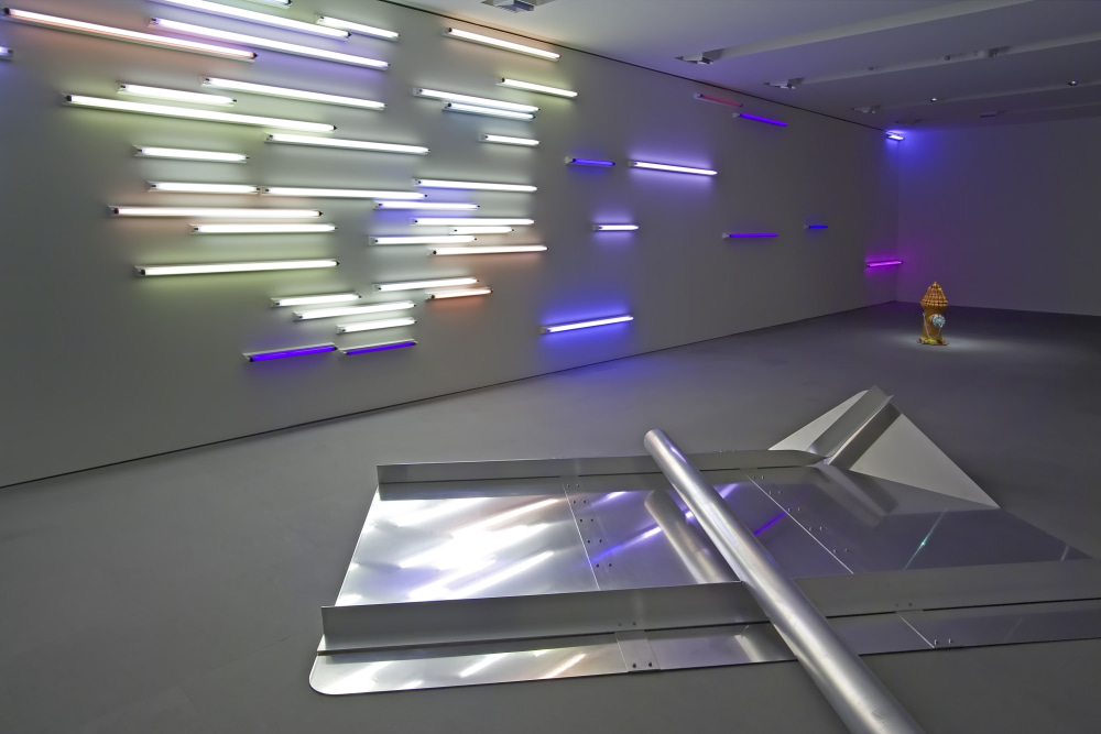 Art gallery installation of an exhibition, with a metal floor sculpture and  neon light piece