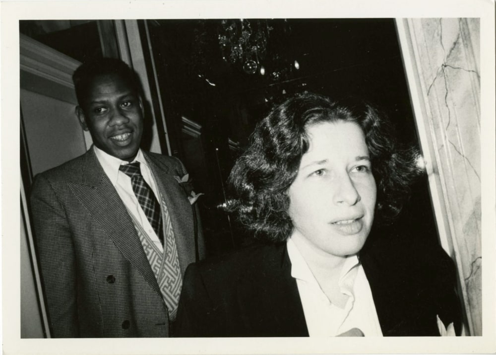 A black and white photograph of Andre Leon Talley and Fran Lebowitz in New York circa 1976 by Bob Colacello
