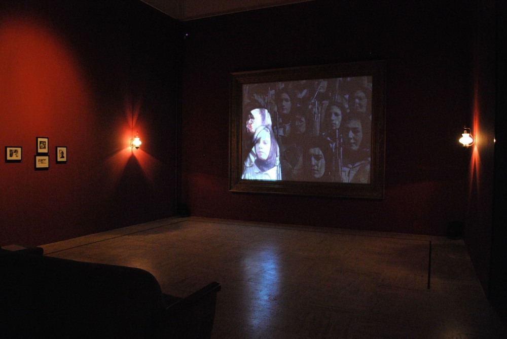 Nalini Malani, Unity in Diversity, 2003. Single channel video installation with sound, furniture, and photographs (7:21 min.). Installation view, Nalini Malani: Splitting the Other, Musée cantonal des Beaux-Arts, Lausanne, France, 2010. Courtesy the artist and Musée cantonal des Beaux-Arts, Lausanne, France. © Nalini Malani.