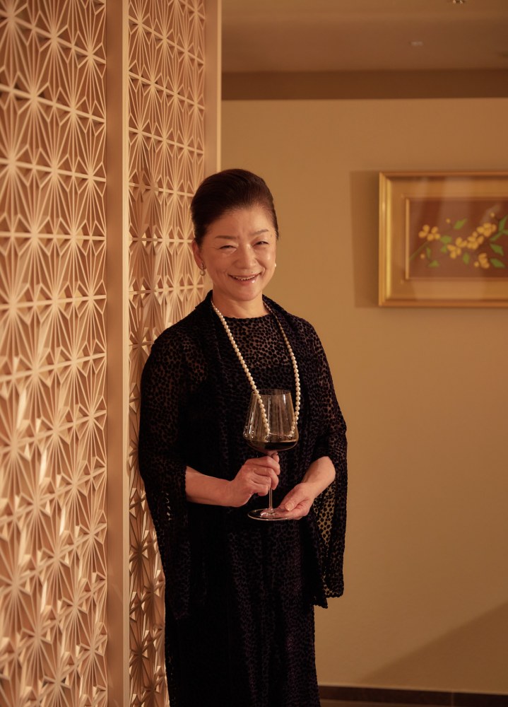 Kenzo Estate co-owner and COO Natsuko Tsujimoto Lady holds a wine glass