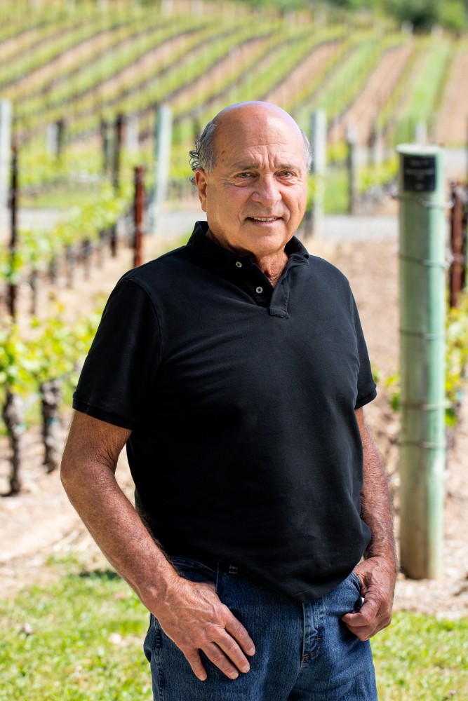 David Abreu, Kenzo Estate viticulturist, holds a glass of wine