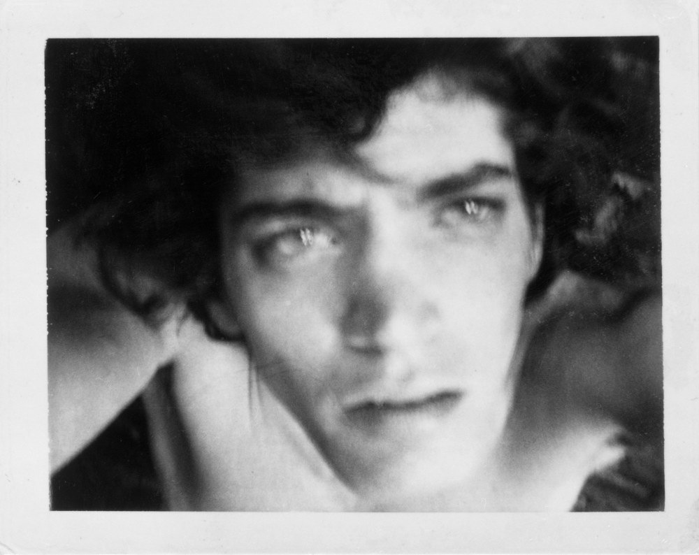 Self-Portrait, Robert Holding the camera above his head, looking up.