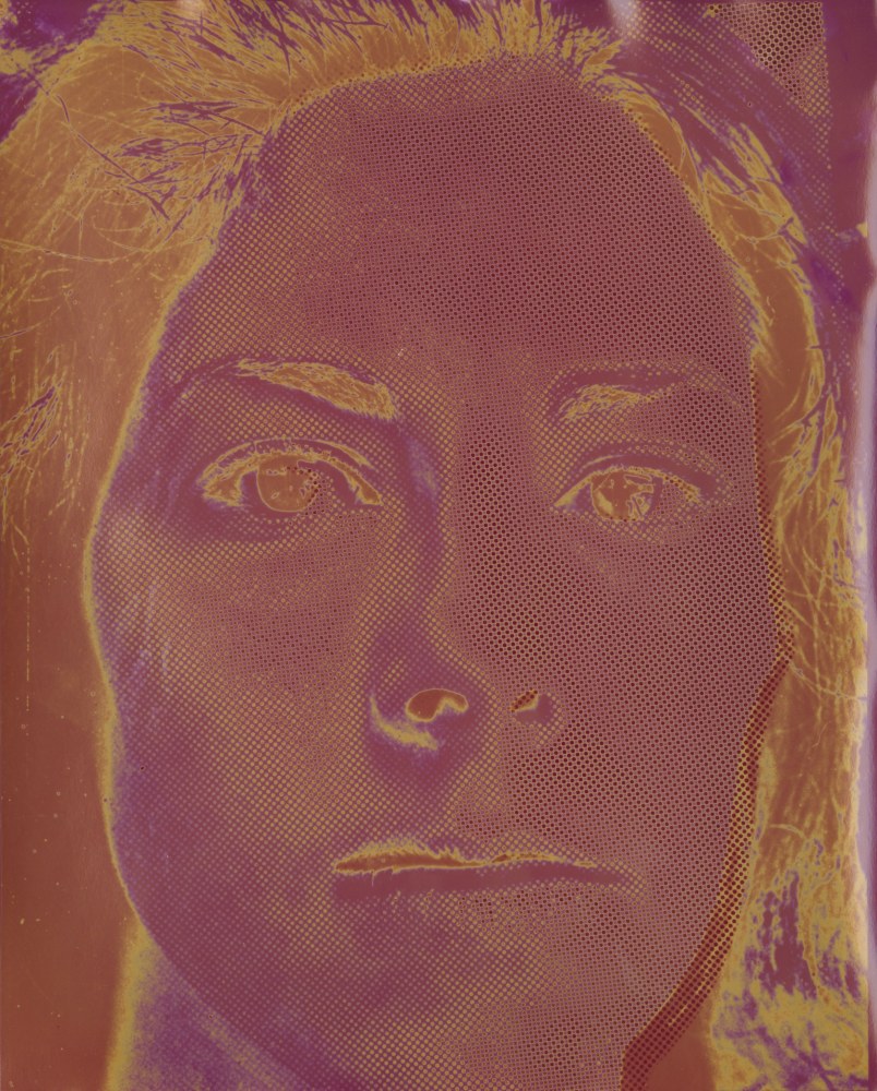 An image of a woman's face is shown graphically edited to feature the colors orange, magenta, and white