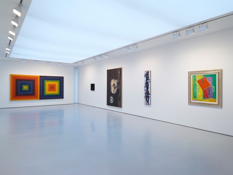 installation view of multiple paintings in a large gallery