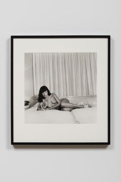 Bettie Page reclining with stuffed animal, 1954