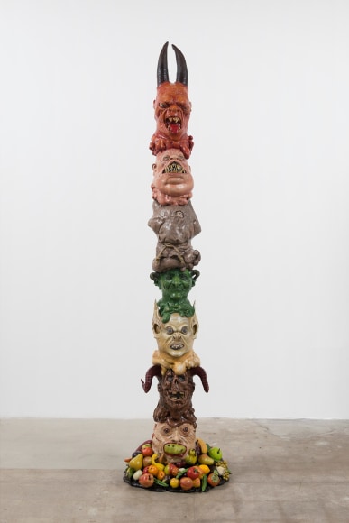 Monster Totem, 2016, Halloween masks, glass eyes, expanding foam, resin, magi-sculpt, fake fruit coated in resin, polyurethane horns, acrylic paint, metal base, wooden pole