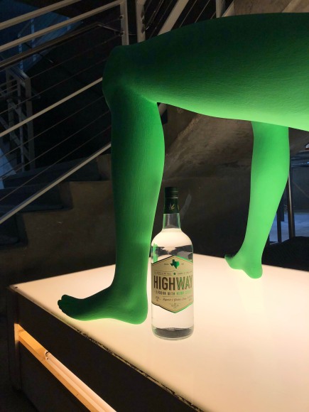 (Description: green female mannequin on illuminated platform)