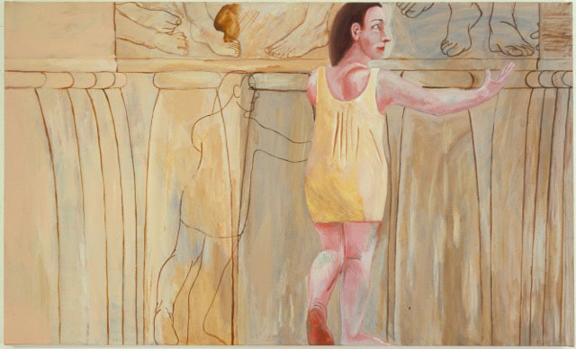 Woman in yellow dress standing in front of ancient ruins