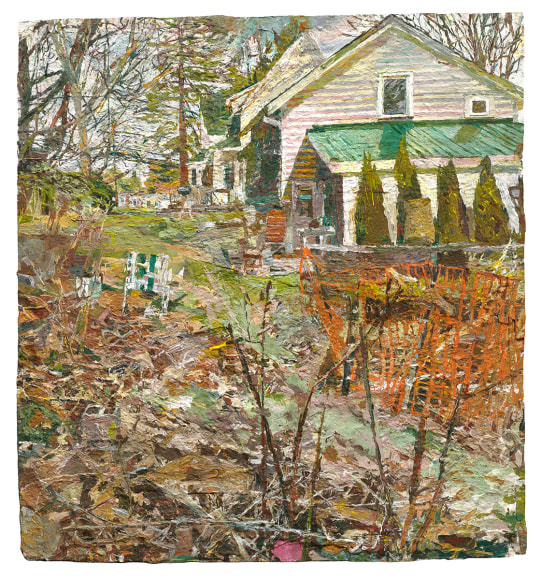 View of a White House with a green roof. In the foreground is a garden fenced in by an orange fence.