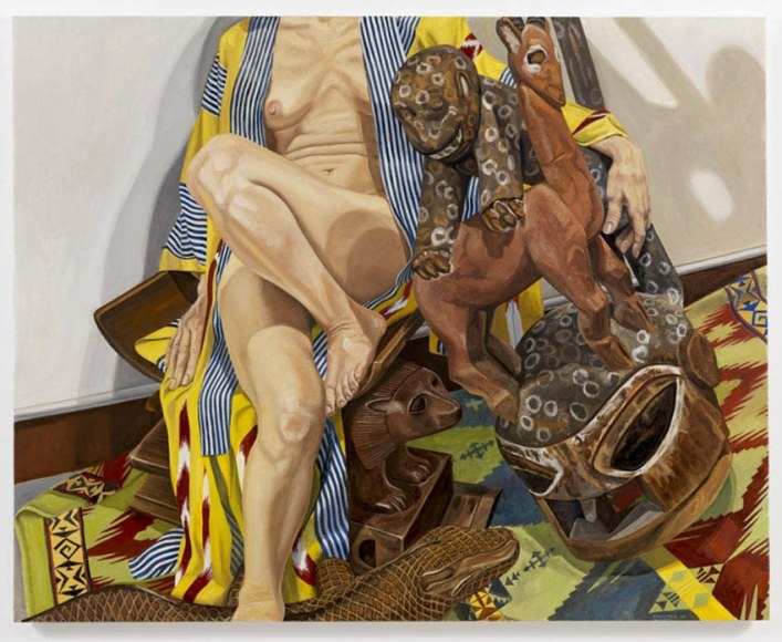 MODEL IN JAPANESE ROBE WITH, AFRICAN CARVINGS, 2009