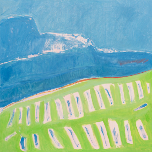 Blue sky, darker blue mountain, green fields below