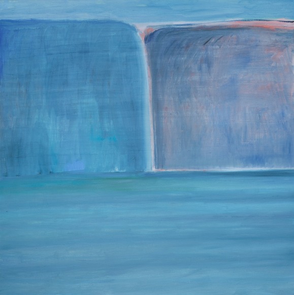 Two blue and purple bluffs, ocean underneath and blue sky above