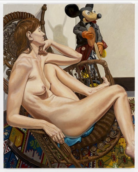 MODEL WITH MICKEY MOUSE ON, UNICYCLE AND WICKER CHAIR, 2009
