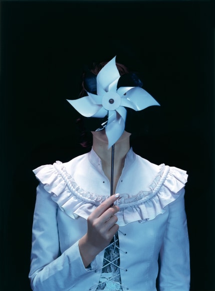 Sophie Delaporte, Early Fashion Work, Model holding handheld paper windmill before face, Sous Les Etoiles Gallery