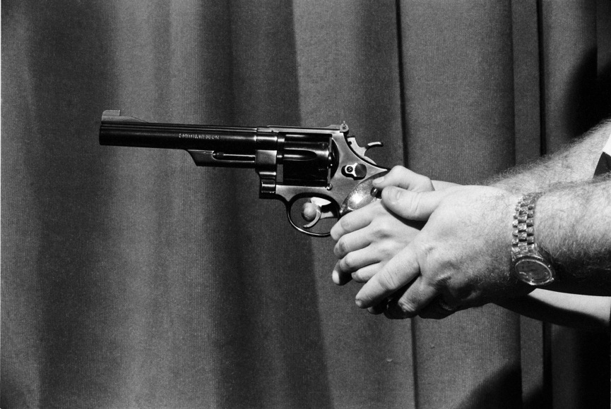 Jean-Pierre Laffont, Children and Guns Instructor holding kid's hand with a gun closeup, Turbulent America, Sous Les Etoiles Gallery