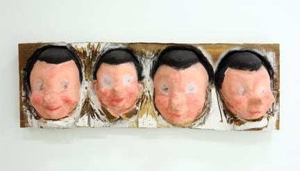 4 Faces Cut Into a Log