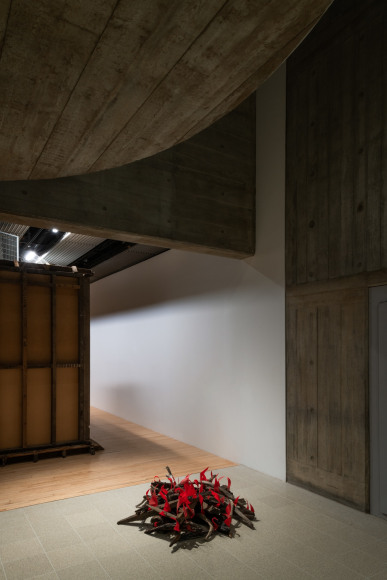 Installation view of Mike Nelson, Amnesiac Beach Fire, 1997 - ongoing. Wood, metal, plastic., Photo: Matt Greenwood. Courtesy the artist and the Hayward Gallery.