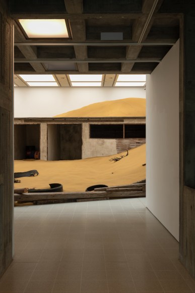 Installation view of Mike Nelson, Triple Bluff Canyon (the woodshed), 2004. Various materials. M25, 2023., Found tyres. Photo: Matt Greenwood. Courtesy the artist and the Hayward Gallery.