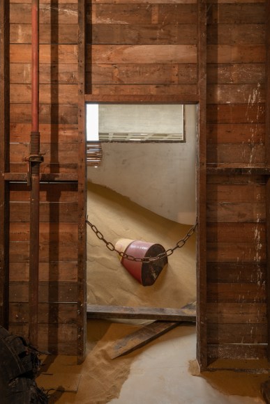 Installation view of Mike Nelson, Triple Bluff Canyon (the woodshed), 2004. Various materials. M25, 2023., Found tyres. Photo: Matt Greenwood. Courtesy the artist and the Hayward Gallery.