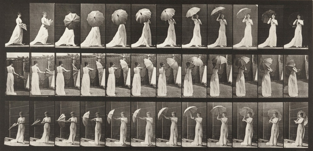 Sequence e of black and white photos showing a woman in a sheer dress opening a parasol.