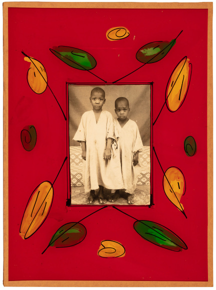 Black and white photo of two young African boys, in a hand painted floral frame