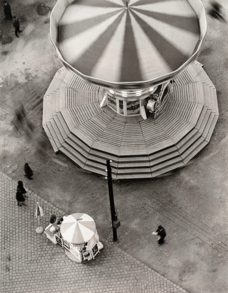Black and white photo of a carnival ride carousel seen from above.