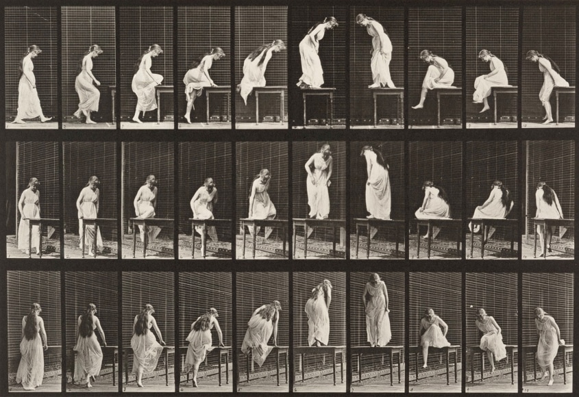 Black and white photo sequence showing the motions of a woman in a sheer dress getting on and off of a table.