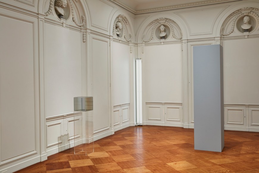 Larry Bell,&nbsp;Old Timer,&nbsp;1969;&nbsp;Dan Flavin, White around a Corner,&nbsp;1965;&nbsp;and Robert Morris, Column,&nbsp;1961/2017,&nbsp;on view in&nbsp;less: minimalism in the 1960s.