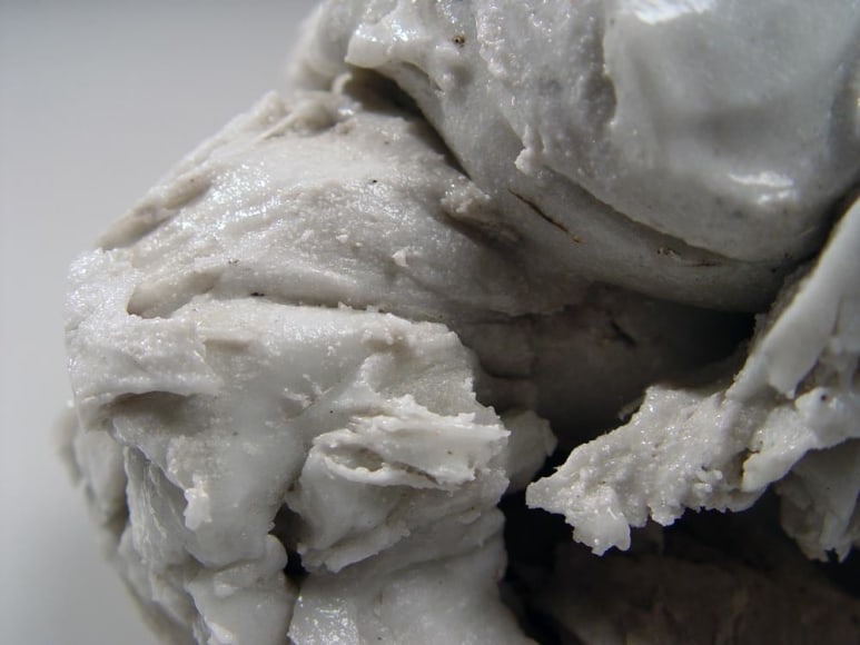 Abstract sculptural form that has been &ldquo;excavated&rdquo; from a larger form with molten glaze in pale green, ca. 2000-2005