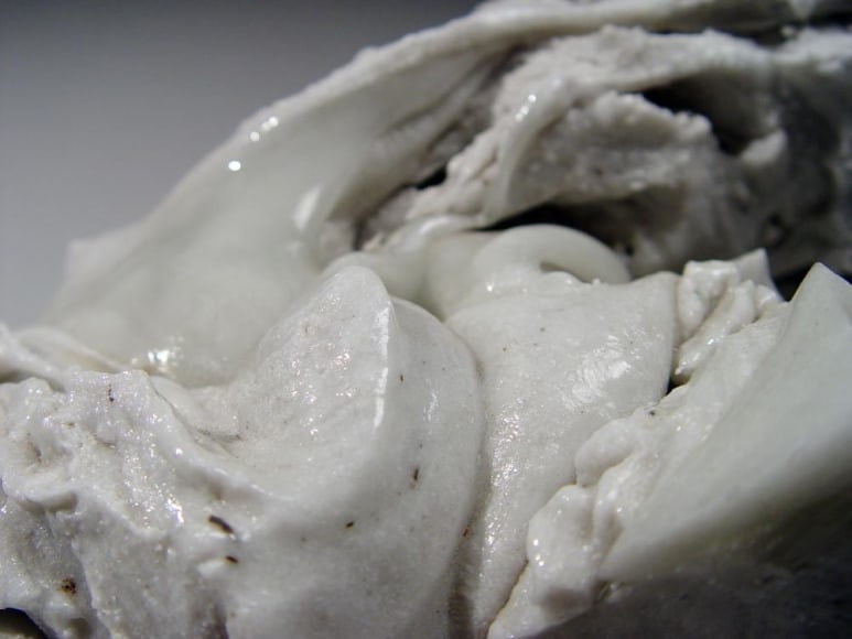 Abstract sculptural form that has been &ldquo;excavated&rdquo; from a larger form with molten glaze in pale green, ca. 2000-2005