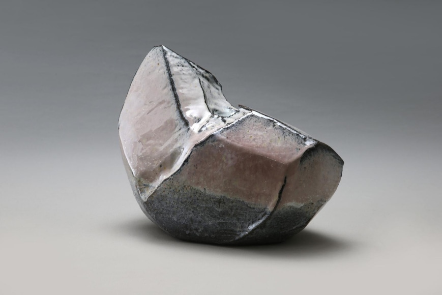 Slightly curved horizontal, sculptural, scooped-out vessel with Hagi and ash glazes with white and pink coloration and extensive kiln effects, 2015