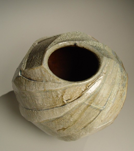 Spherical Tanba vessel with faceted diagonal banding and dripping natural ash glaze and markings from impressed shells, 2011
