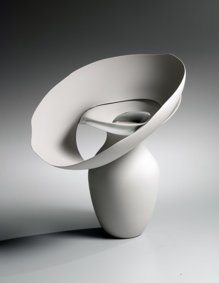 Vase-like unglazed base topped with wide, outspread tiered open, cascading flattened rings conjoined with shiny pale gray glaze between the tiers titled,&nbsp;Kumo; Clouds