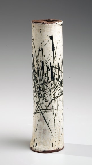 White cylindrical vase with vertical black spatter design&nbsp;, 1970s