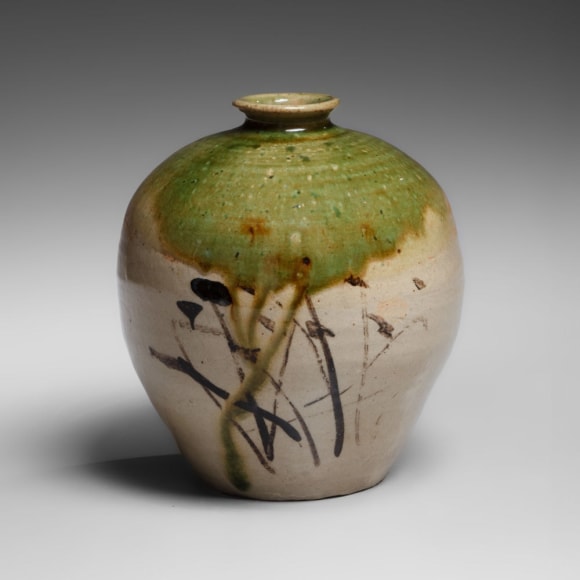 An earthenware Oribe-style jar with iron-oxide wild grass patterning