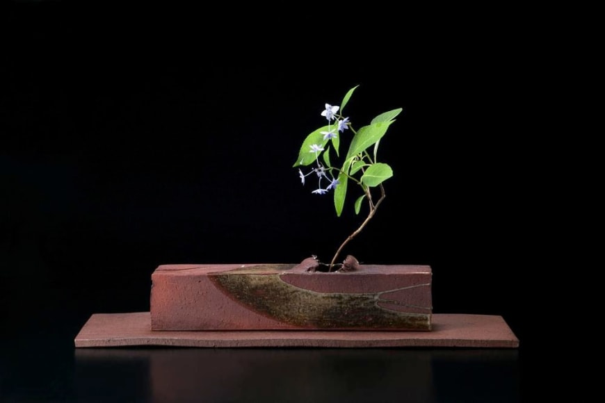 Rectangular sculpted container rests on a flat base, titled TAIRAGI, 2010