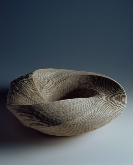 Large, ﬂattened round vessel with diagonally incised cascading folds 