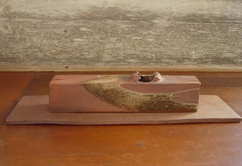 Rectangular sculpted container rests on a flat base, titled TAIRAGI, 2010