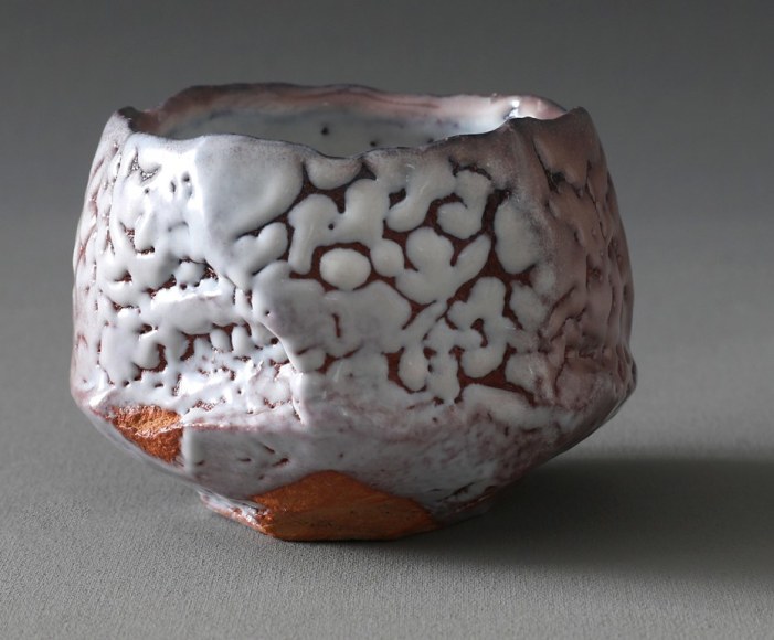 Kaneta Masanao (b. 1953), Round teabowl with irregular mouth, split foot rim, &quot;crawling&quot; Hagi&nbsp;glaze and kiln effects&nbsp;