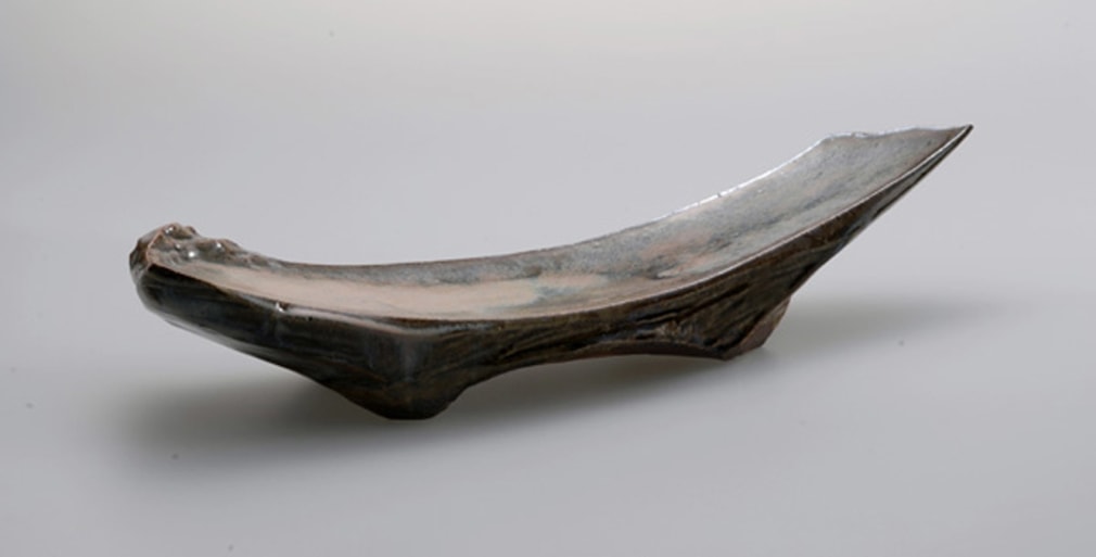 Bowed, footed slab platter covered with Hagi glaze in pink, gray and brown colorations 