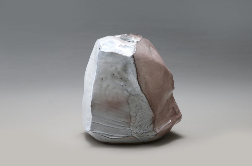 Mountain-shaped, scooped-out vessel with multi-planar body covered with Hagi white glaze divided by deep pink toned areas, and kiln effects, 2015